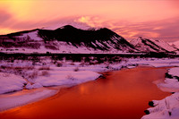 A deep red sunset fills the sky around Mount Emmons also known as The Red Lady
