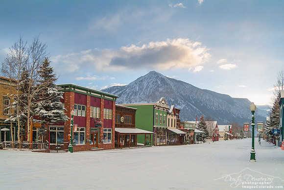 Snowy spring sunrise over Elk Avenue shops in Crested Butte Colorado